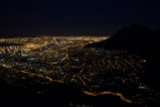 Cape Town glows below.